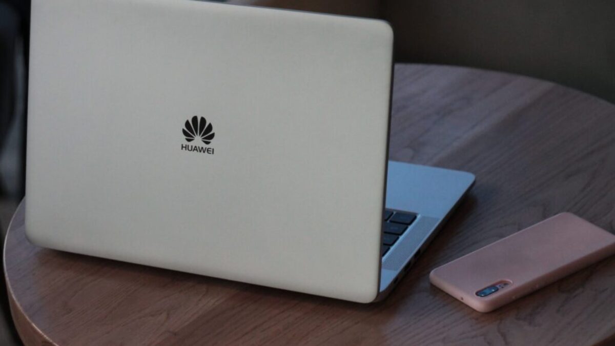 silver macbook on brown wooden table