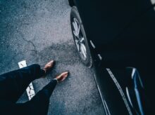 person standing near car