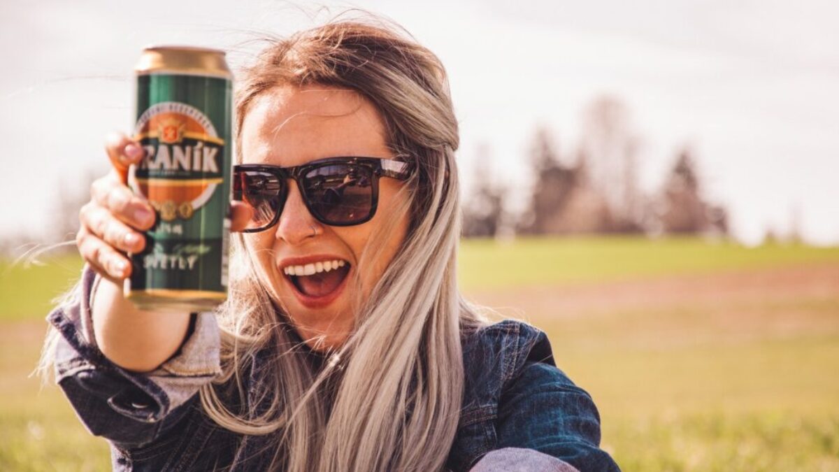 woman holding soda can