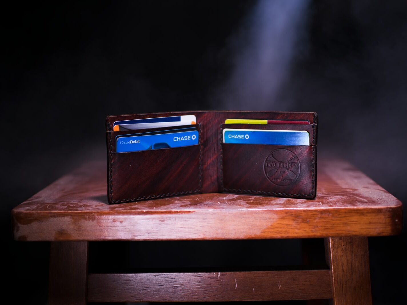 brown leather bifold wallet on table
