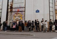 people queuing beside Louis Vuitton store