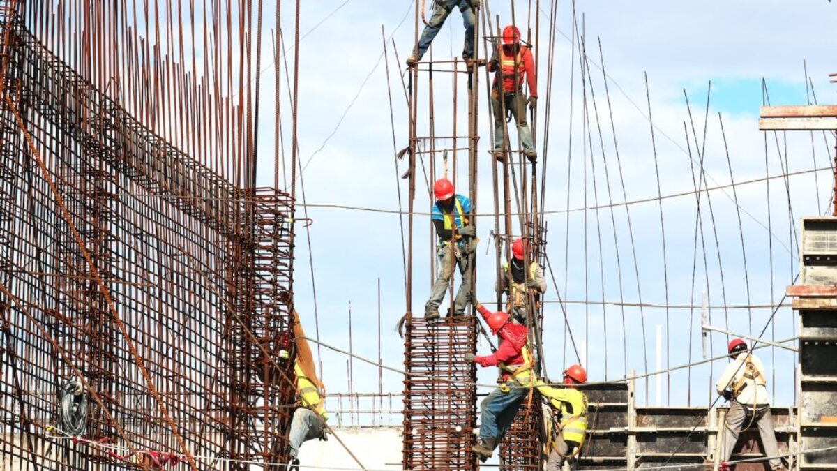 people working on building during daytime