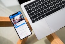 iPhone X beside MacBook