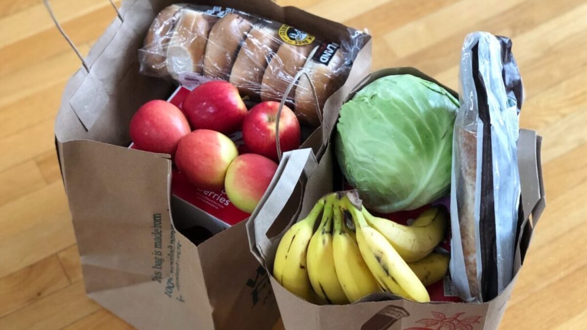 apples and bananas in brown cardboard box