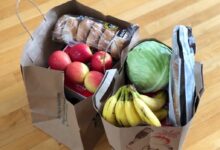 apples and bananas in brown cardboard box