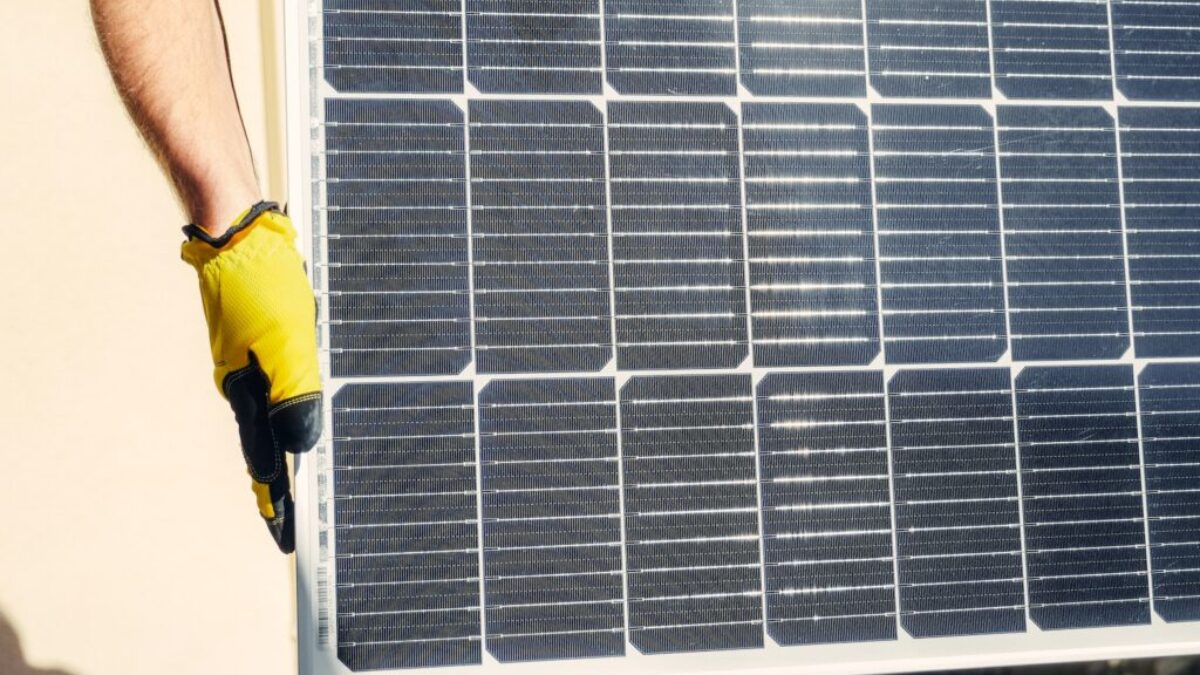 A Person Carrying a Solar Panel