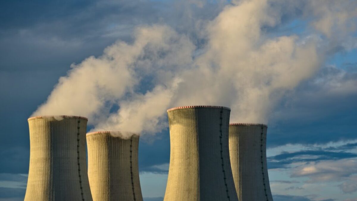 gray concrete towers under white clouds and blue sky during daytime