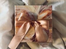 white and brown floral paper on white textile