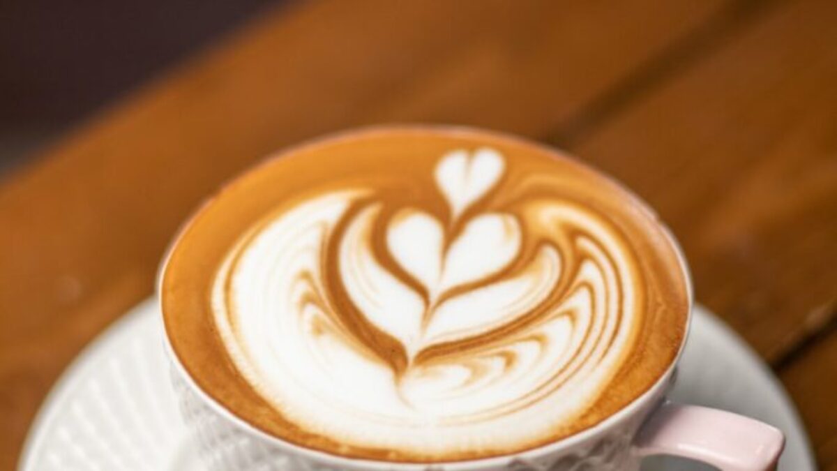 white ceramic cup with saucer on brown wooden table