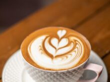 white ceramic cup with saucer on brown wooden table
