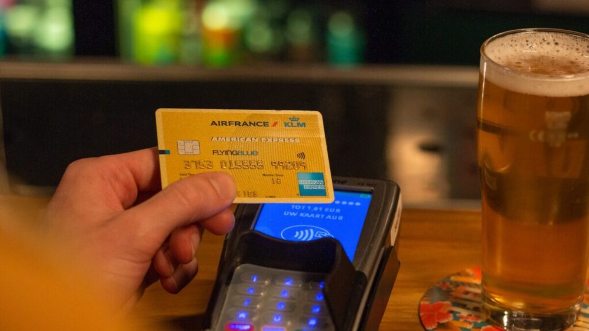 person holding yellow and blue card