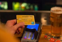 person holding yellow and blue card