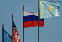 The flags of Roscosmos, the United States, Russia, and Kazakhstan are seen at the Soyuz launch pad