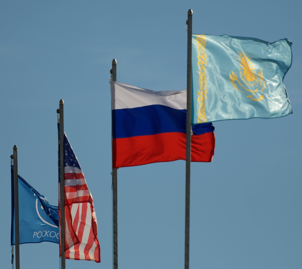 The flags of Roscosmos, the United States, Russia, and Kazakhstan are seen at the Soyuz launch pad