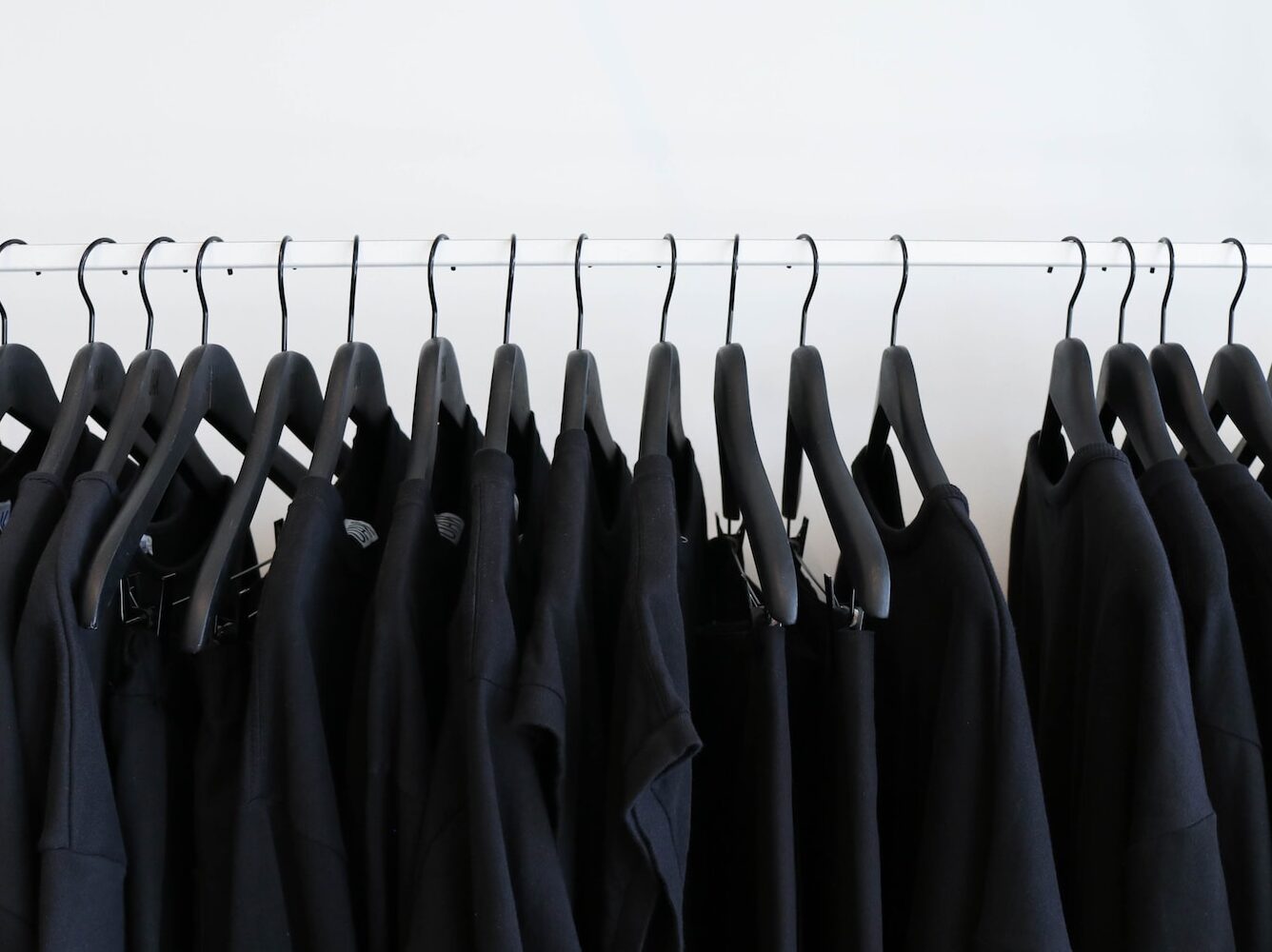 black clothes hanged in rack
