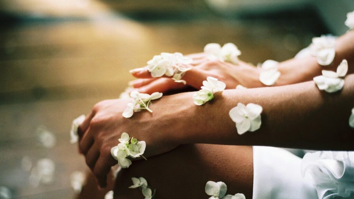person surrounded by white flowers