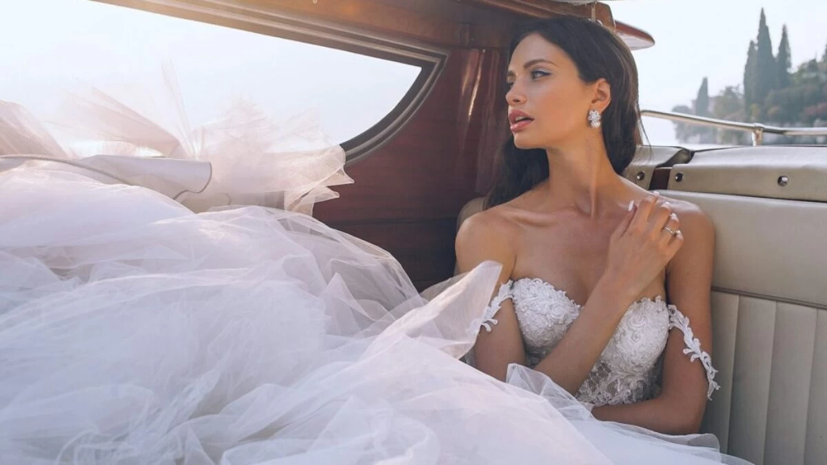 woman wearing white sweetheart-neckline wedding dress inside vehicle