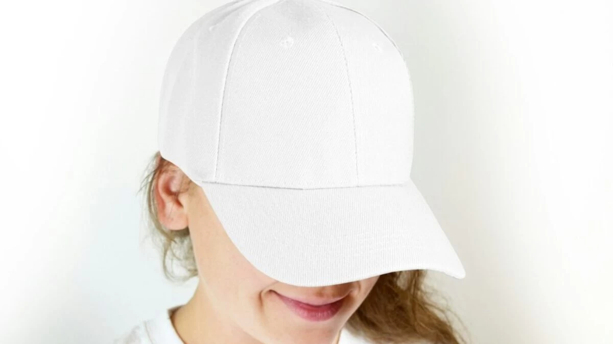 woman in white crew neck shirt wearing white cap