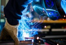 man holding gray steel frame