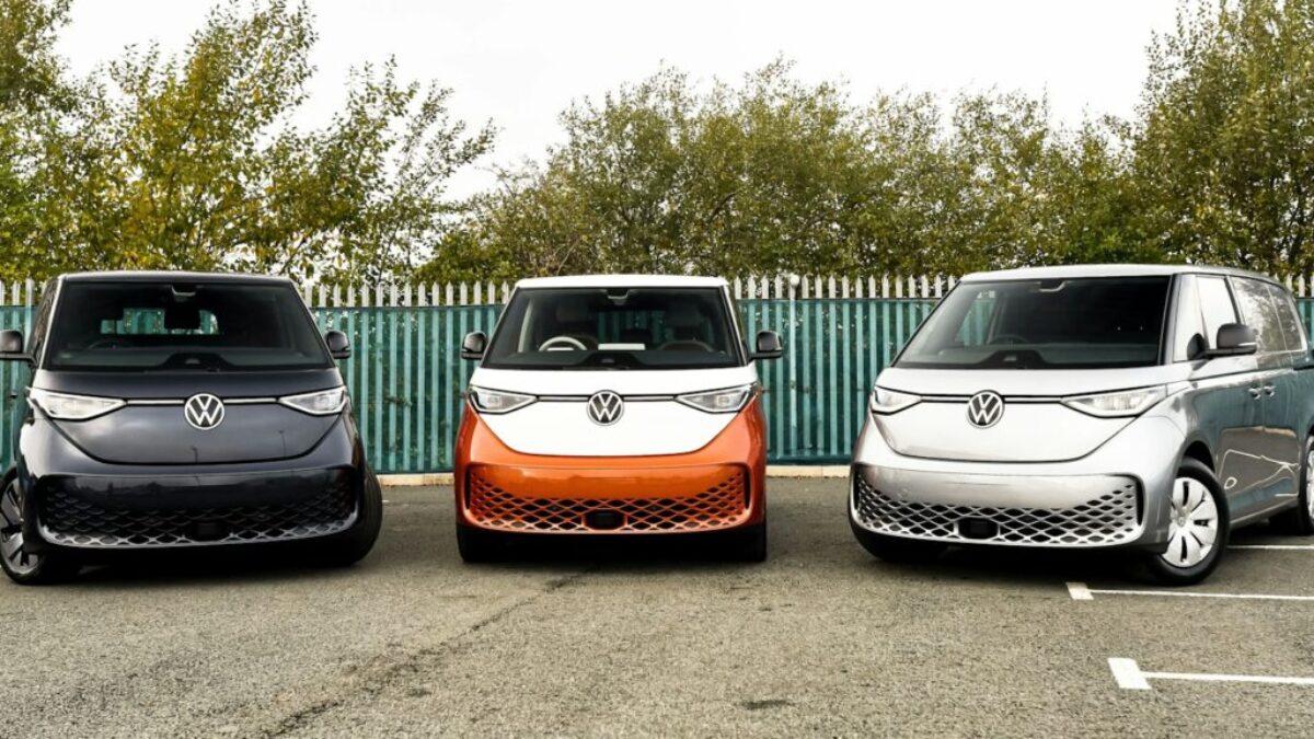 three electric vehicles parked in a parking lot
