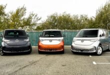 three electric vehicles parked in a parking lot
