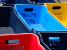 a row of plastic bins sitting next to each other
