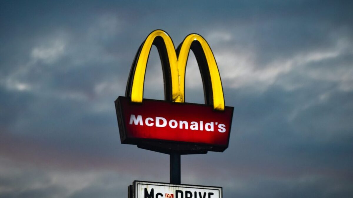 a mcdonald's sign with a cloudy sky in the background