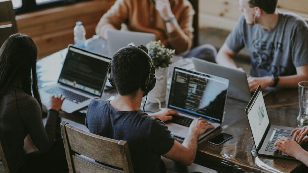 group of people using laptop computer
