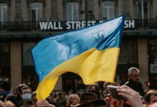 Blue and yellow Ukrainian Flag Waving Above Crowd of People