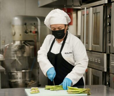 chef holding green and yellow plastic tray