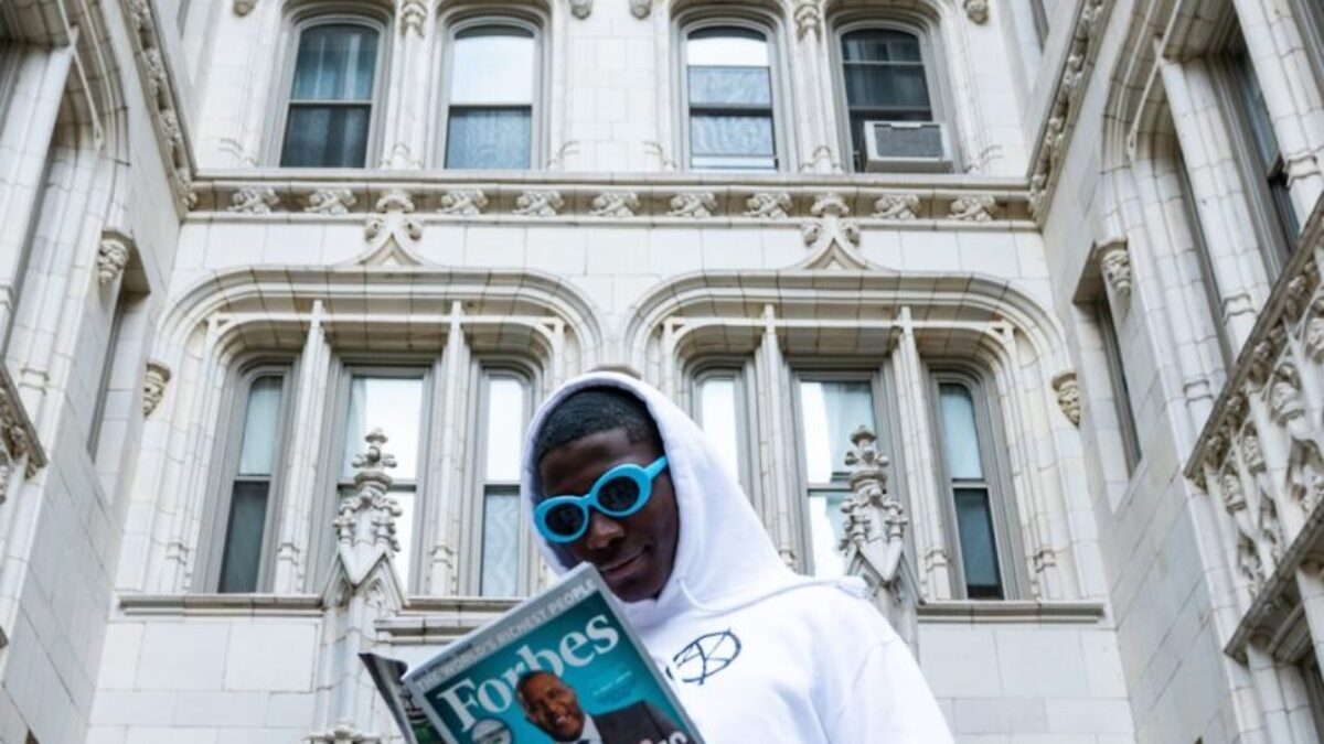 man in white thobe holding book