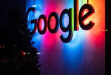 the google logo is lit up at night