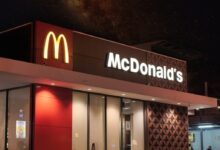a mcdonald's restaurant is lit up at night