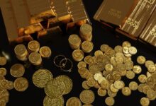 a table topped with lots of gold coins