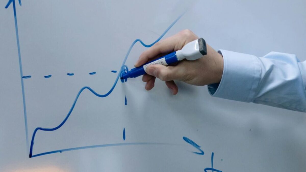 A Person Writing on a Whiteboard