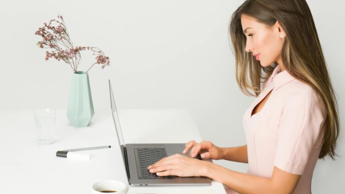 Woman in Pink Dress Using Laptop Computer