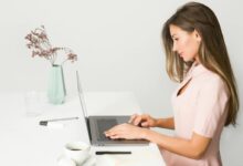 Woman in Pink Dress Using Laptop Computer