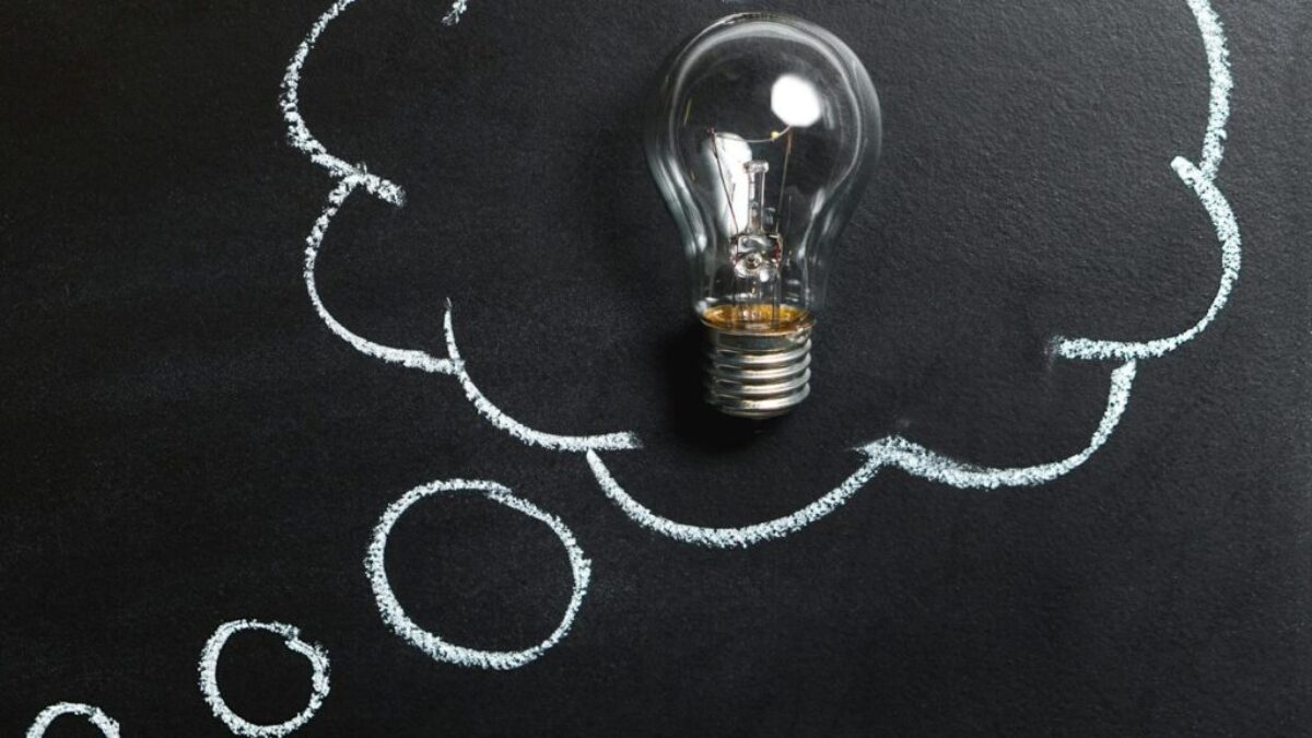 Clear Light Bulb Placed on Chalkboard