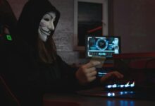 Woman in Black Hoodie Holding a Bank Card