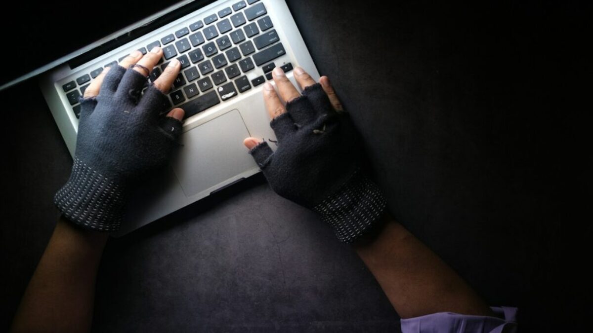 person in black long sleeve shirt using macbook pro