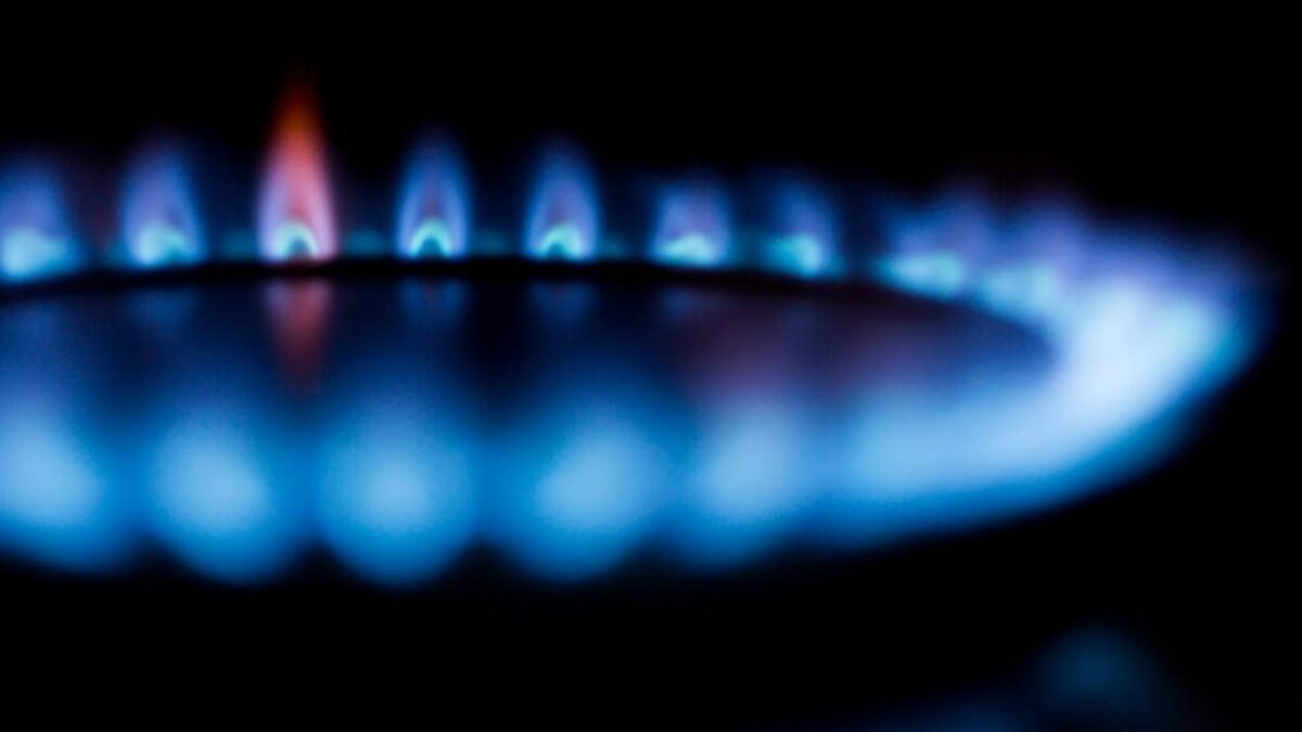 Blurred image of a blue gas stove flame, highlighting heat and energy.
