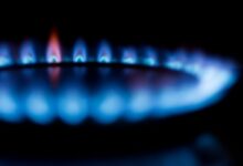 Blurred image of a blue gas stove flame, highlighting heat and energy.