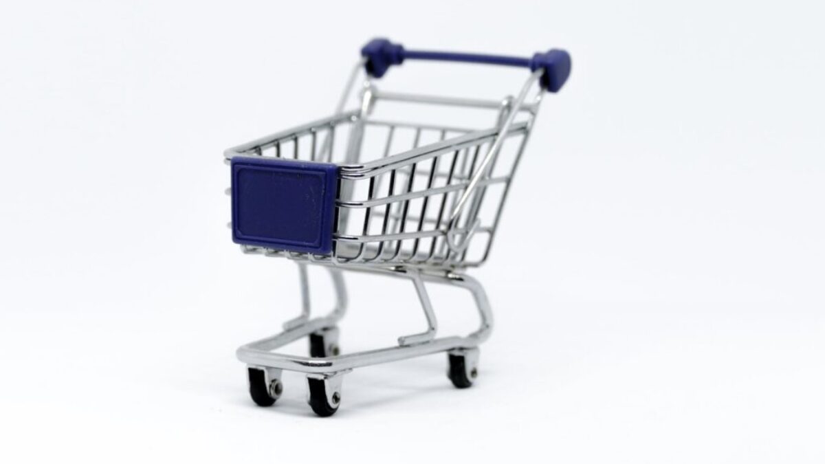 A modern miniature shopping cart on a clean white background, perfect for e-commerce concepts.