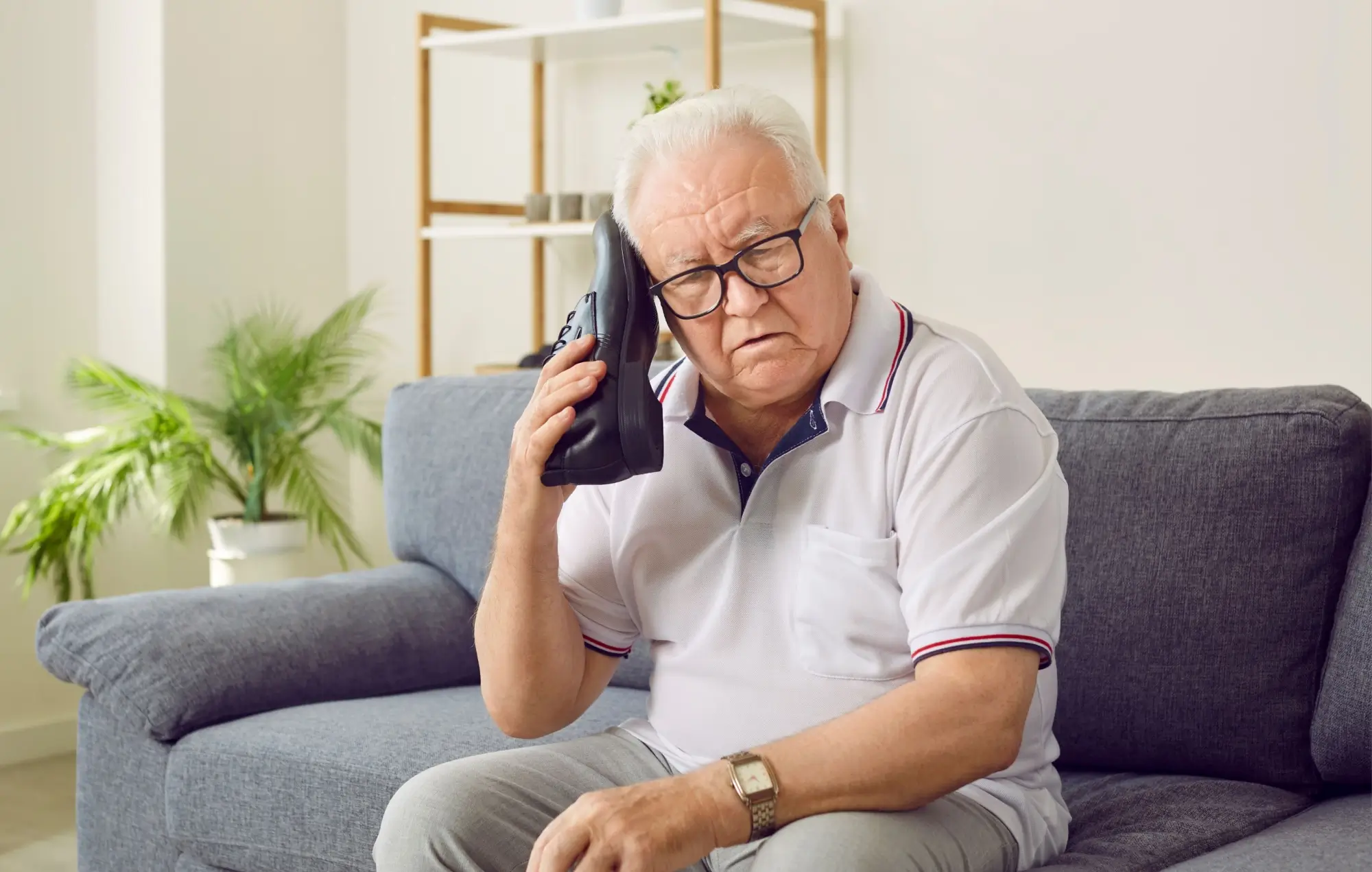 Shutterstock_2244247895 - ByznysDeník Starší muž považující botu za telefon