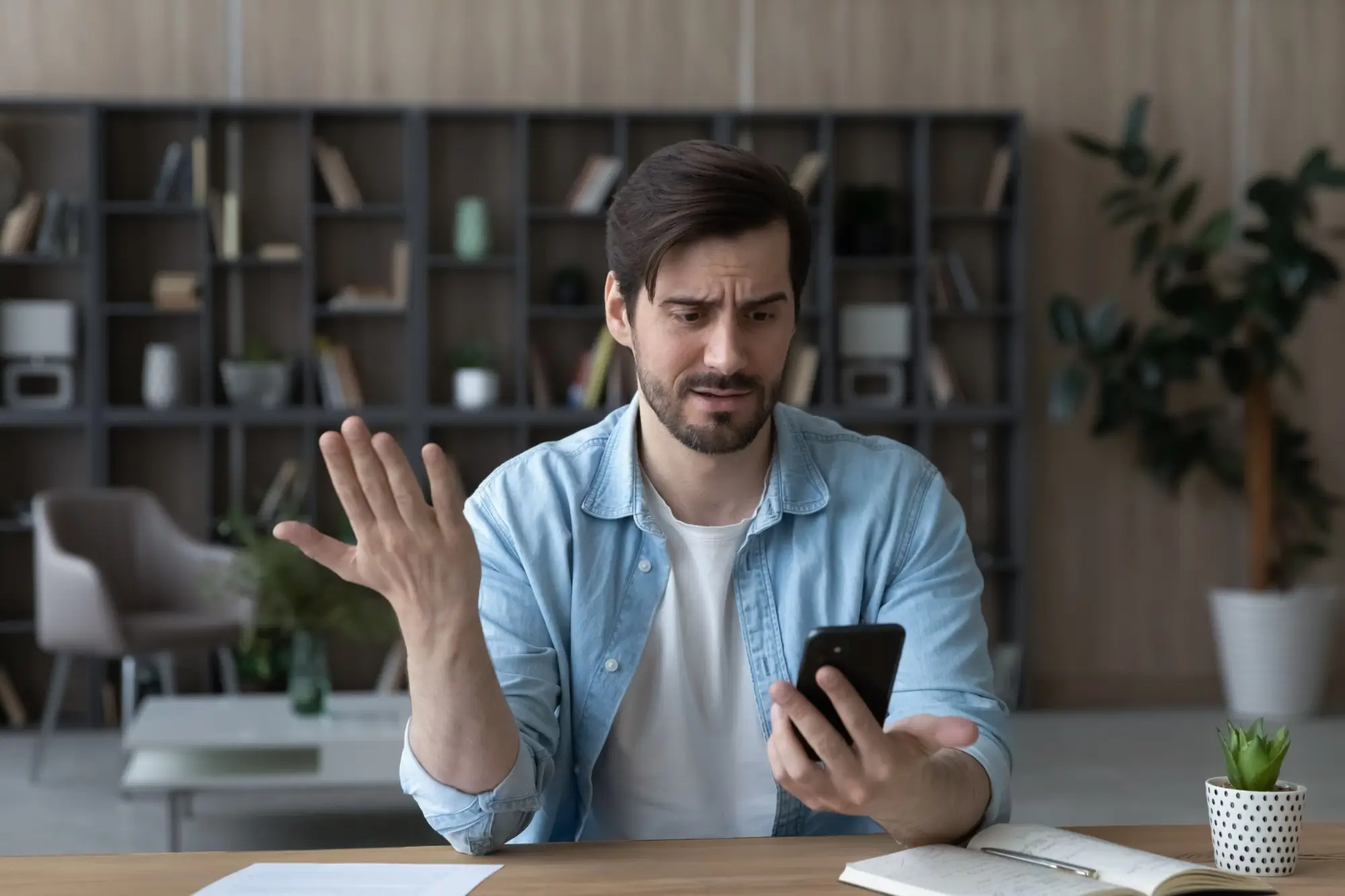Muž se diví u mobilního telefonu
