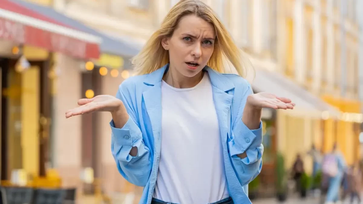 Žena rozpažuje dlaně na kameru.