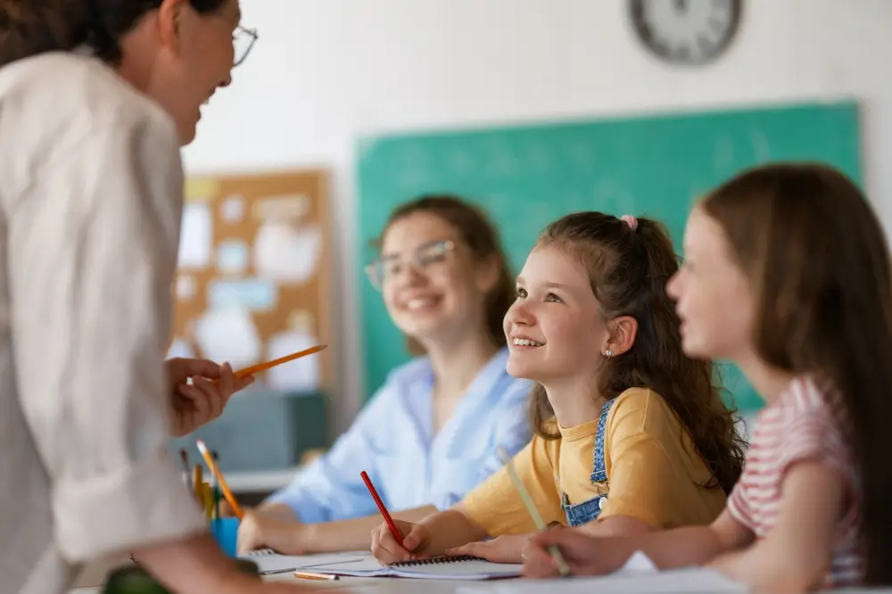 shutterstock_2492437907 - ByznysDeník Učitelka mluví k žákyním.