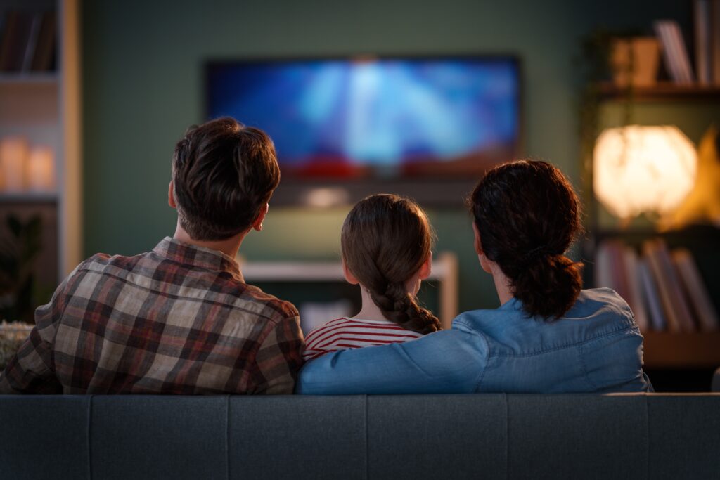 Pravidelným restartováním televize zajistíte plynulé streamování pořadů bez zádrhelů, Zdroj: Shutterstock.com - ByznysDeník Šťastná rodina tráví společný čas u TV