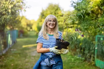 Žena nese rostlinu