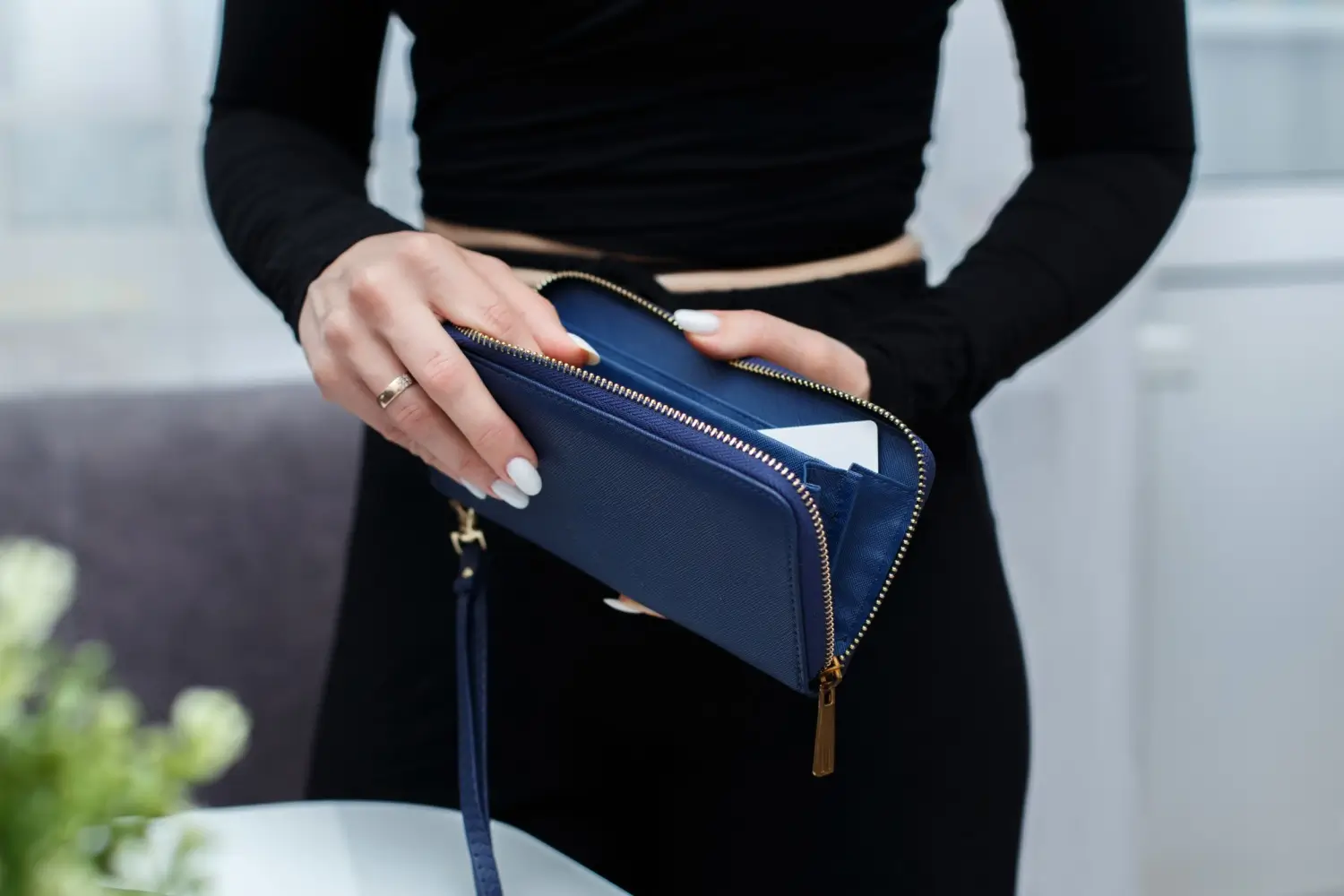 Žena drží modrou peněženku